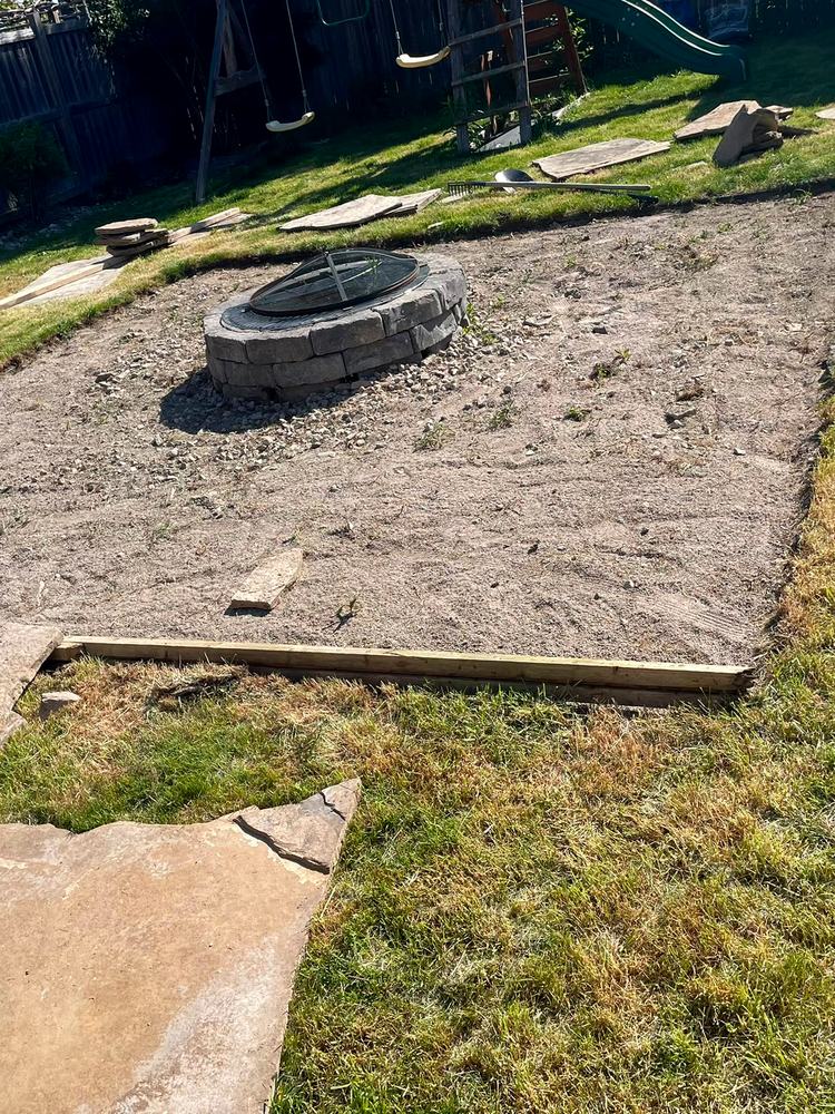 Old patio stripped to a dirt pad around the fire pit