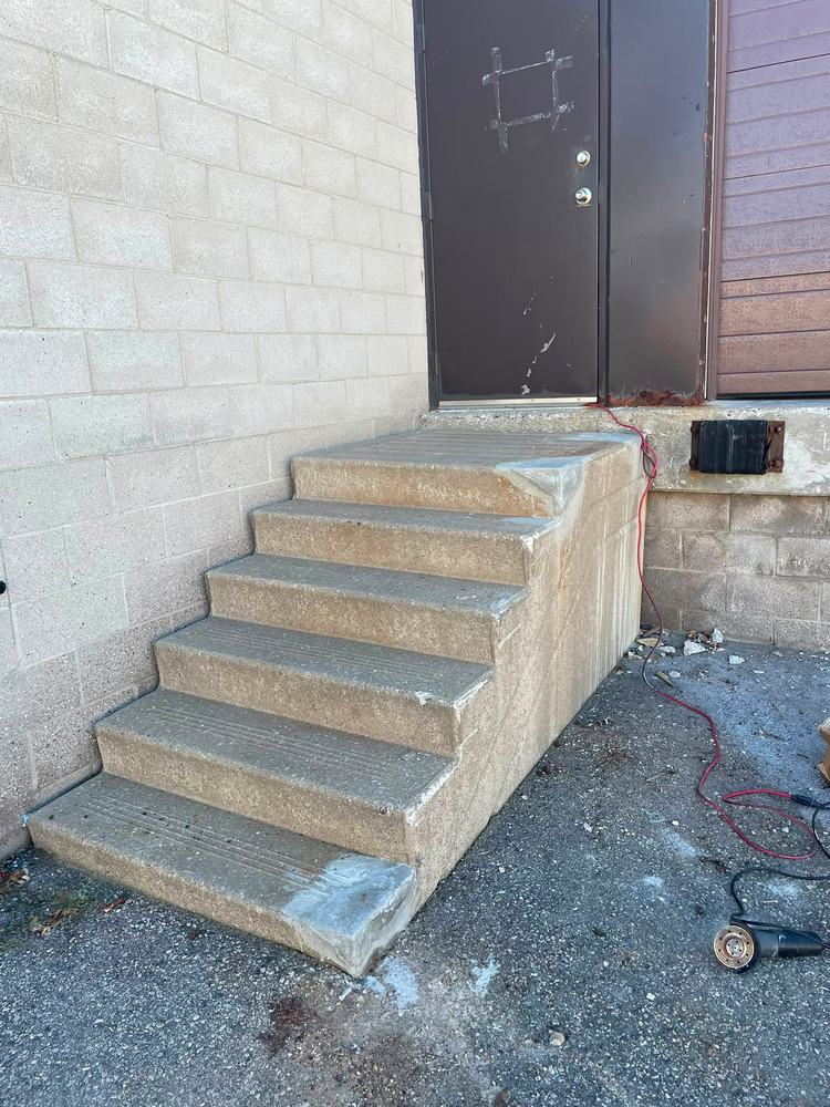 Bare concrete steps with no handrail