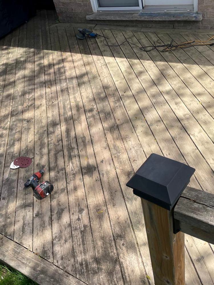 Worn grey deck boards before restoration
