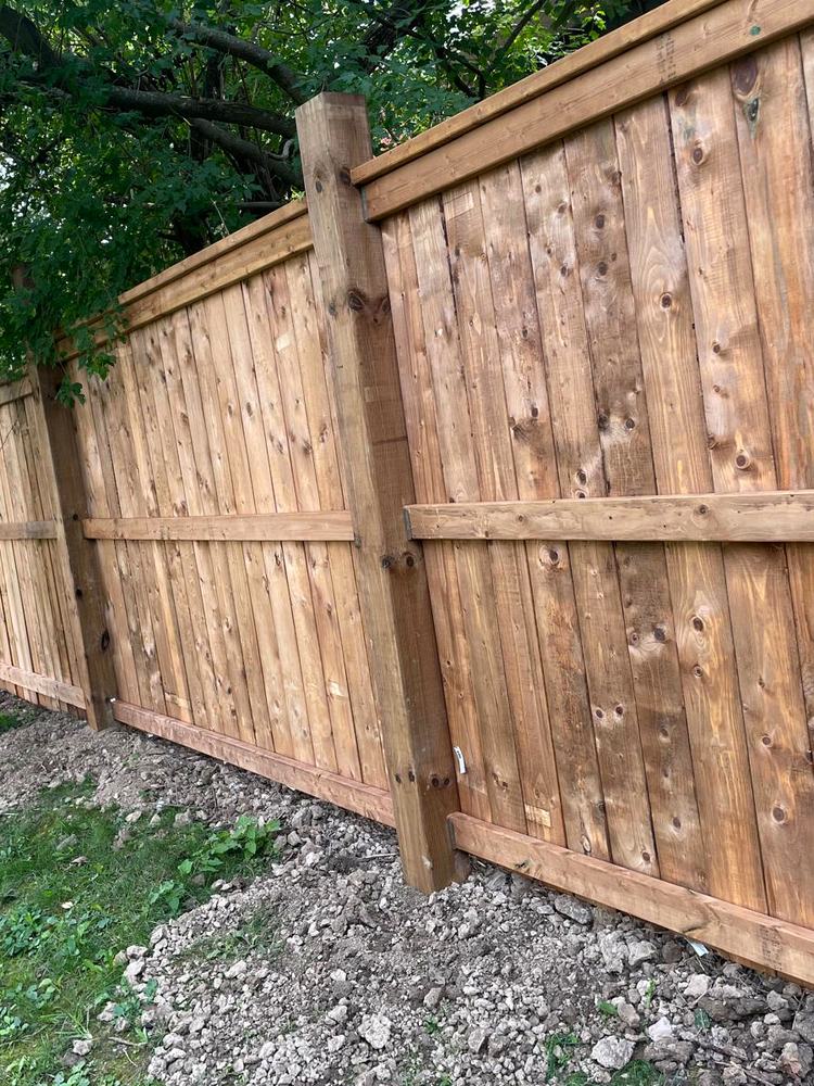 New stained privacy fence installed along the line