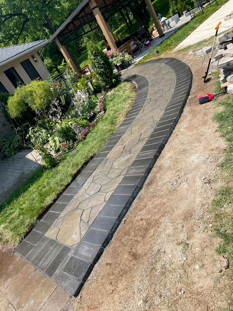 New flagstone walkway with charcoal paver border