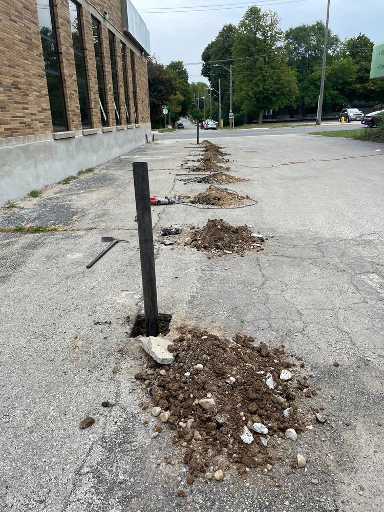 Steel posts set in fresh concrete