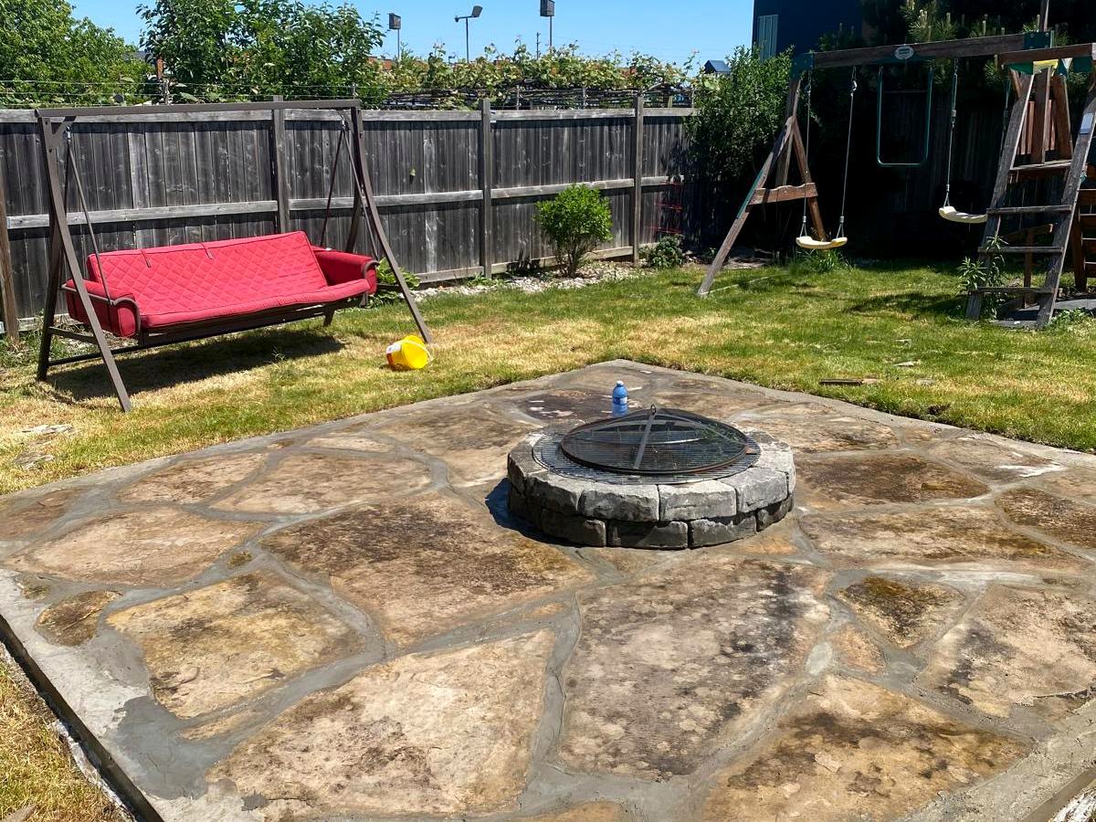 Finished flagstone fire pit patio in a London backyard