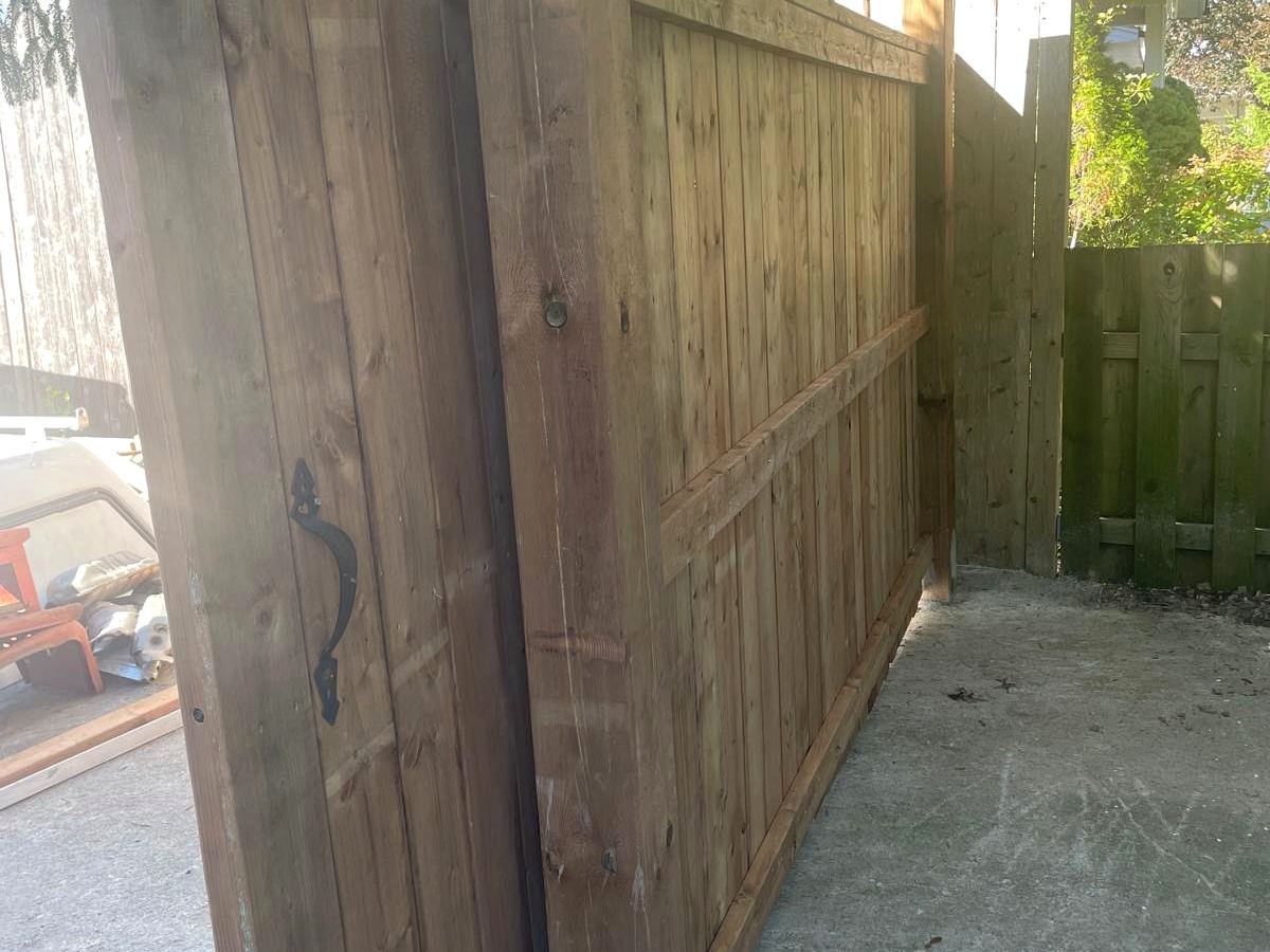Dark stained privacy fence and custom gate, completed